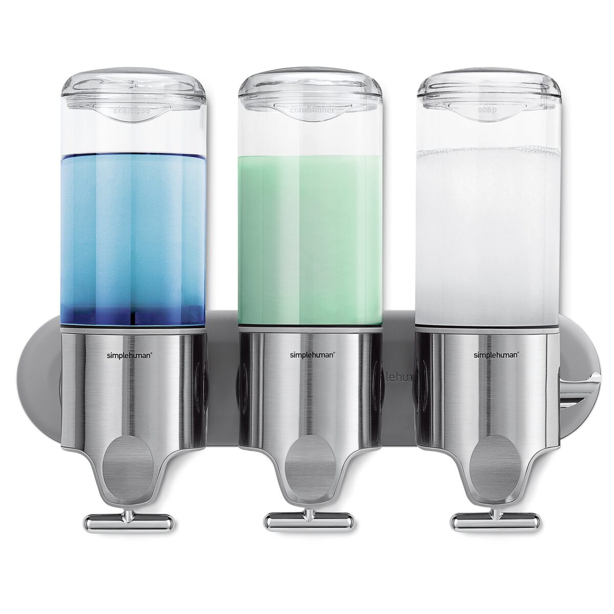 A wall-mounted dispenser system with three clear containers filled with different colored liquids - blue, green, and clear. The dispensers are labeled for shampoo, conditioner, and soap, and are made of stainless steel and plastic.